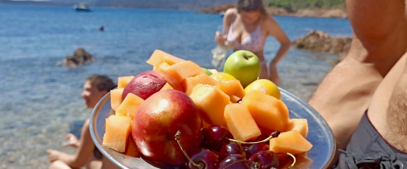 9177c6ba-5228-4d19-be42-7962ffaaf862 a person sitting at a table with a bowl of fruit