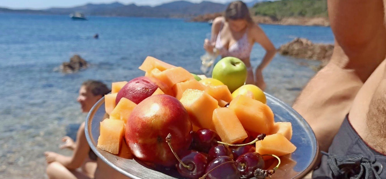 9177c6ba-5228-4d19-be42-7962ffaaf862 a person sitting at a table with a bowl of fruit