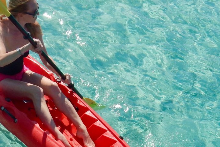 a person standing next to a body of water