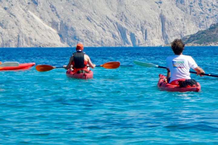 a group of people rowing a boat in a body of water