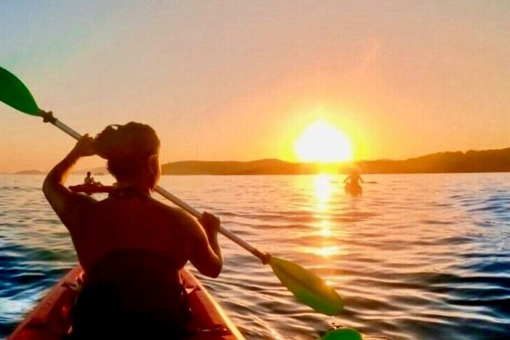a person sitting in front of a body of water