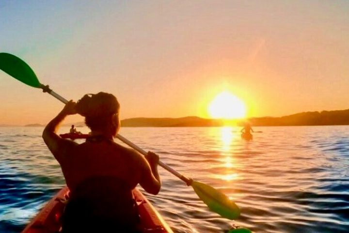 a person sitting in front of a body of water