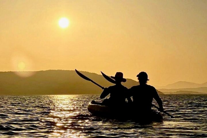 a man standing next to a body of water