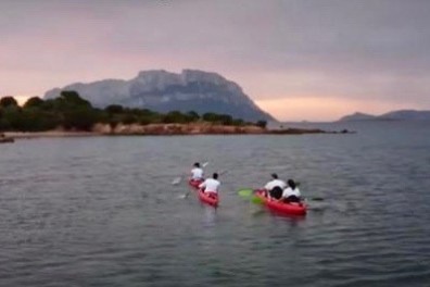 a group of people in a small boat in a body of water