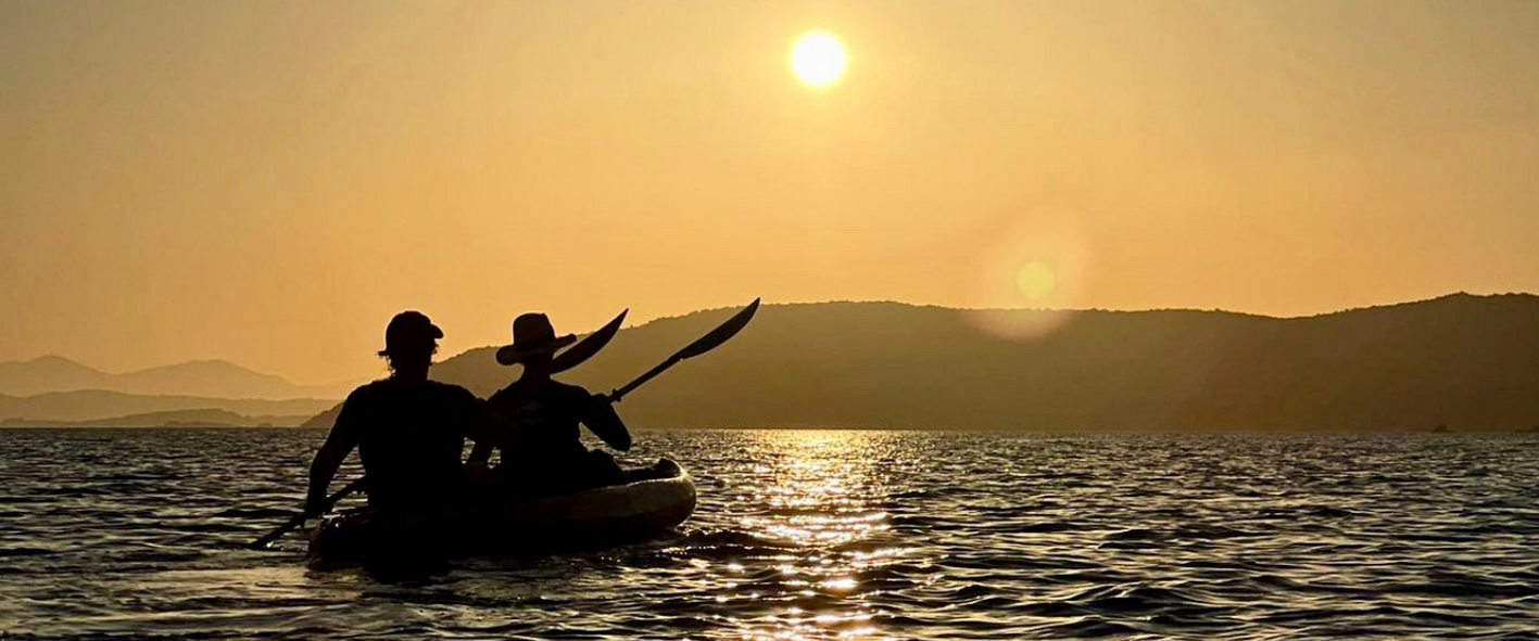 a man standing next to a body of water