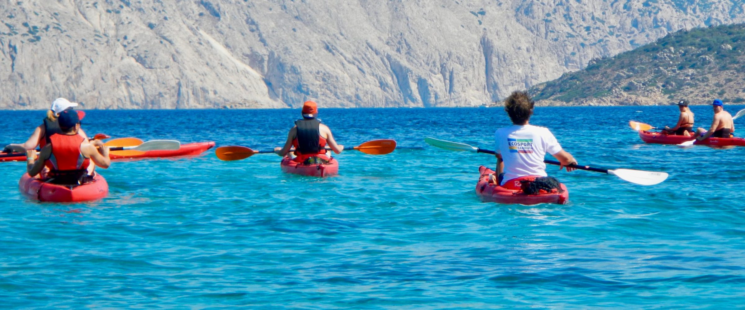 a group of people rowing a boat in a body of water
