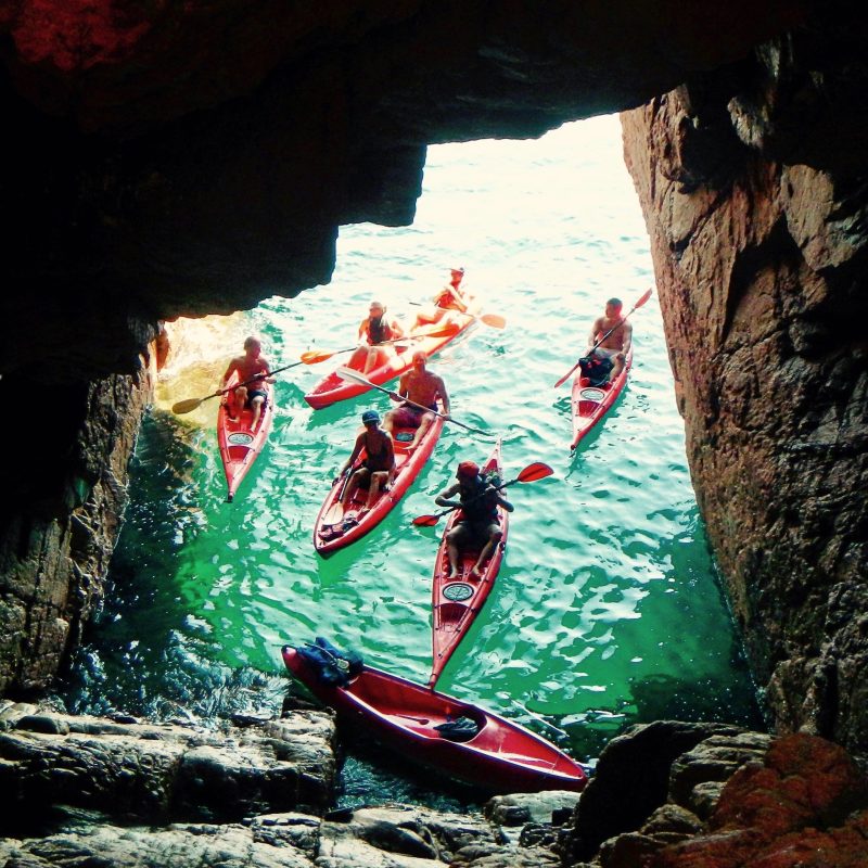 a person riding a surfboard on top of a rock