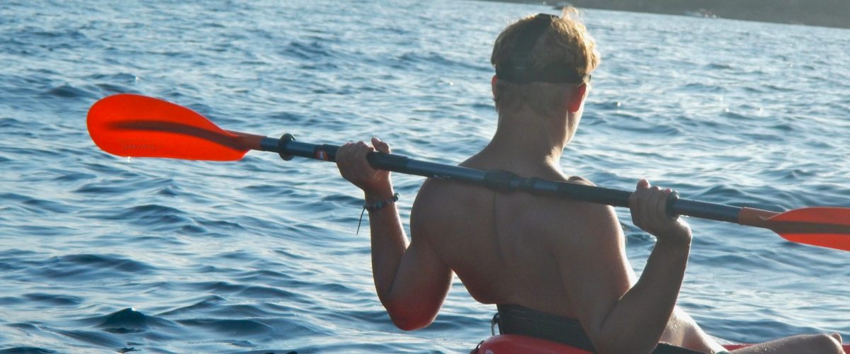 a person rowing a boat in a body of water