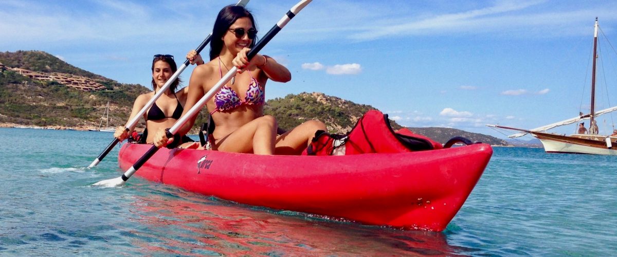 a person riding on the back of a boat in a body of water