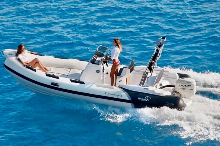 a person riding on the back of a boat in a body of water
