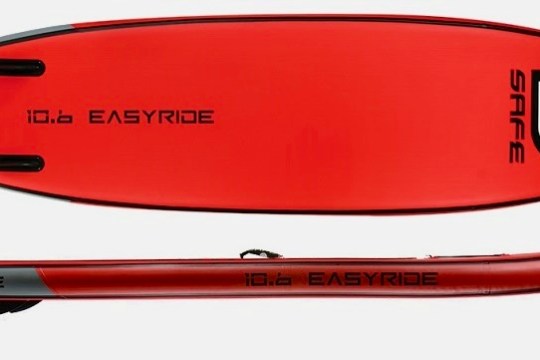 Red inflatable paddle board labeled 'SAFE' and '10.6 EASYRIDE' with fins visible.