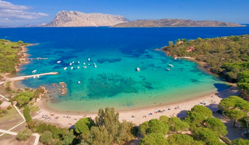 a large body of water with a mountain in the background