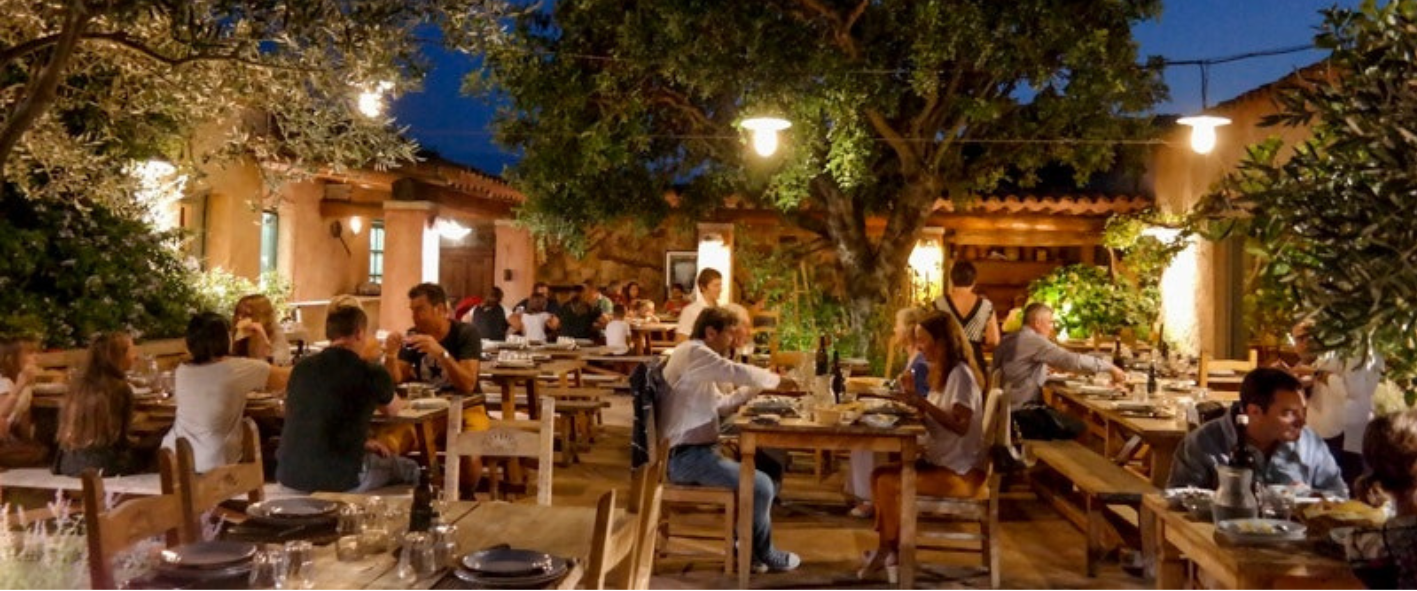 a group of people sitting at a table in a restaurant