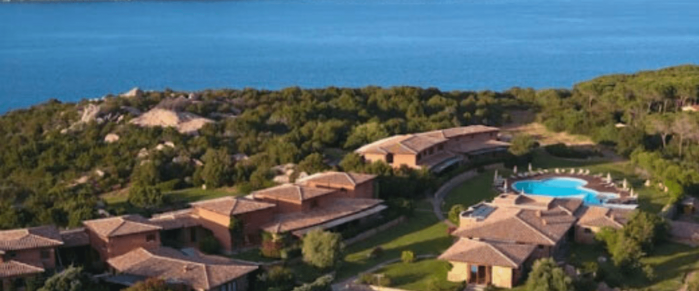 a close up of a hillside next to a body of water