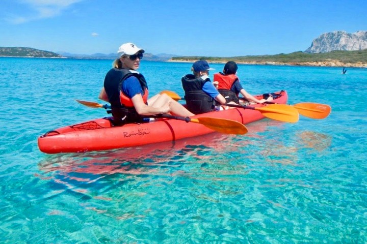 a group of people in a small boat in a body of water
