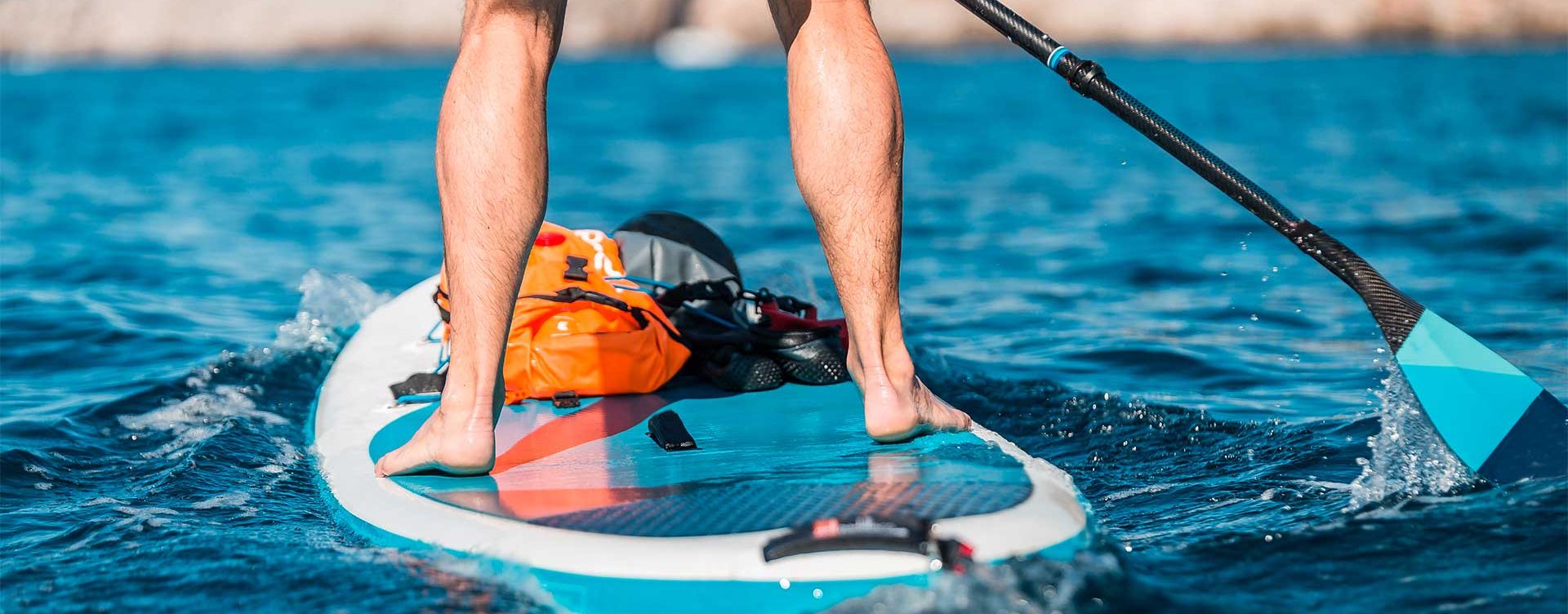 supitalyacademy-brevetti a person riding a surf board on a body of water